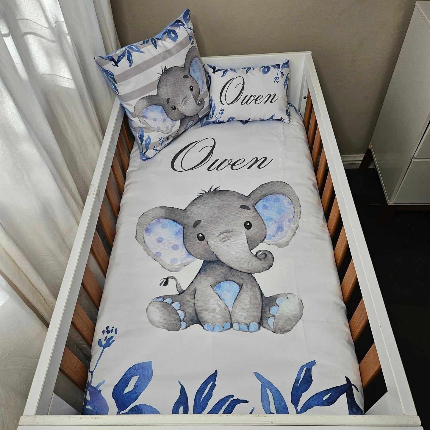 Owen the cute Baby Blue Ellie cot linen +