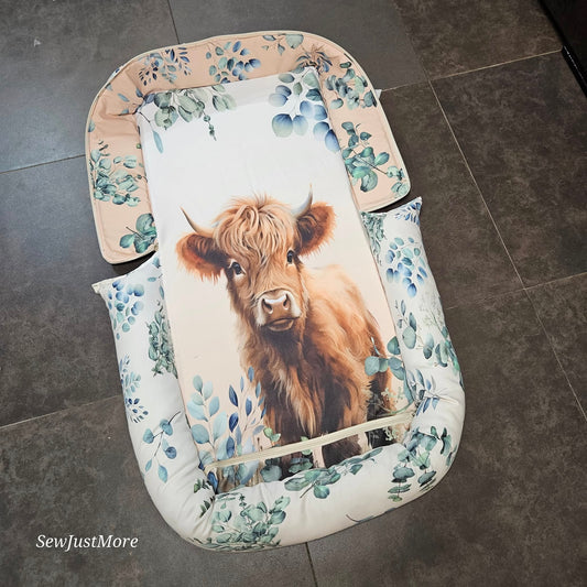 The Baby Highland cow travel nest bag